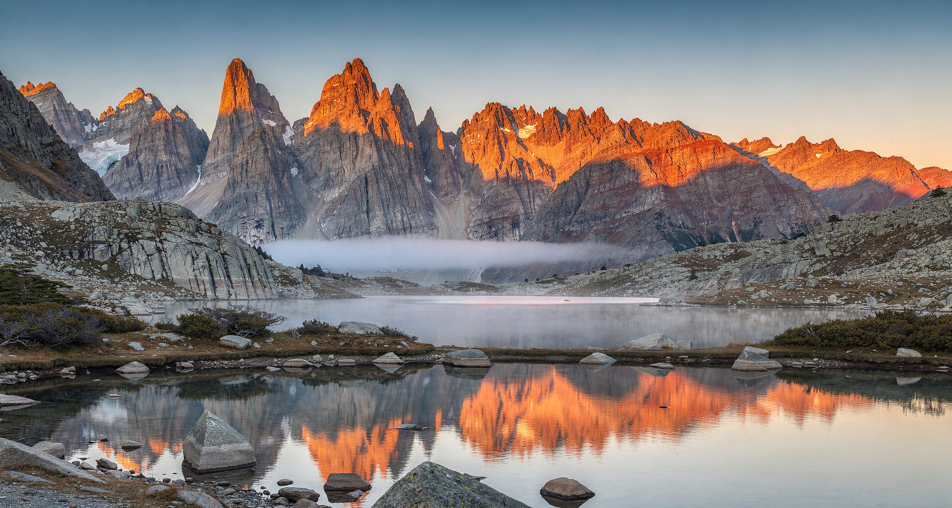 Cuernos del Paine mountain towers reflected in glacial lake water at dusk